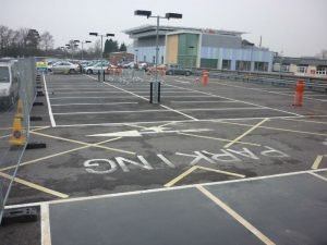 car park with orange bollards and markings on the floor