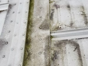white dirty mouldy building roof before cleaning